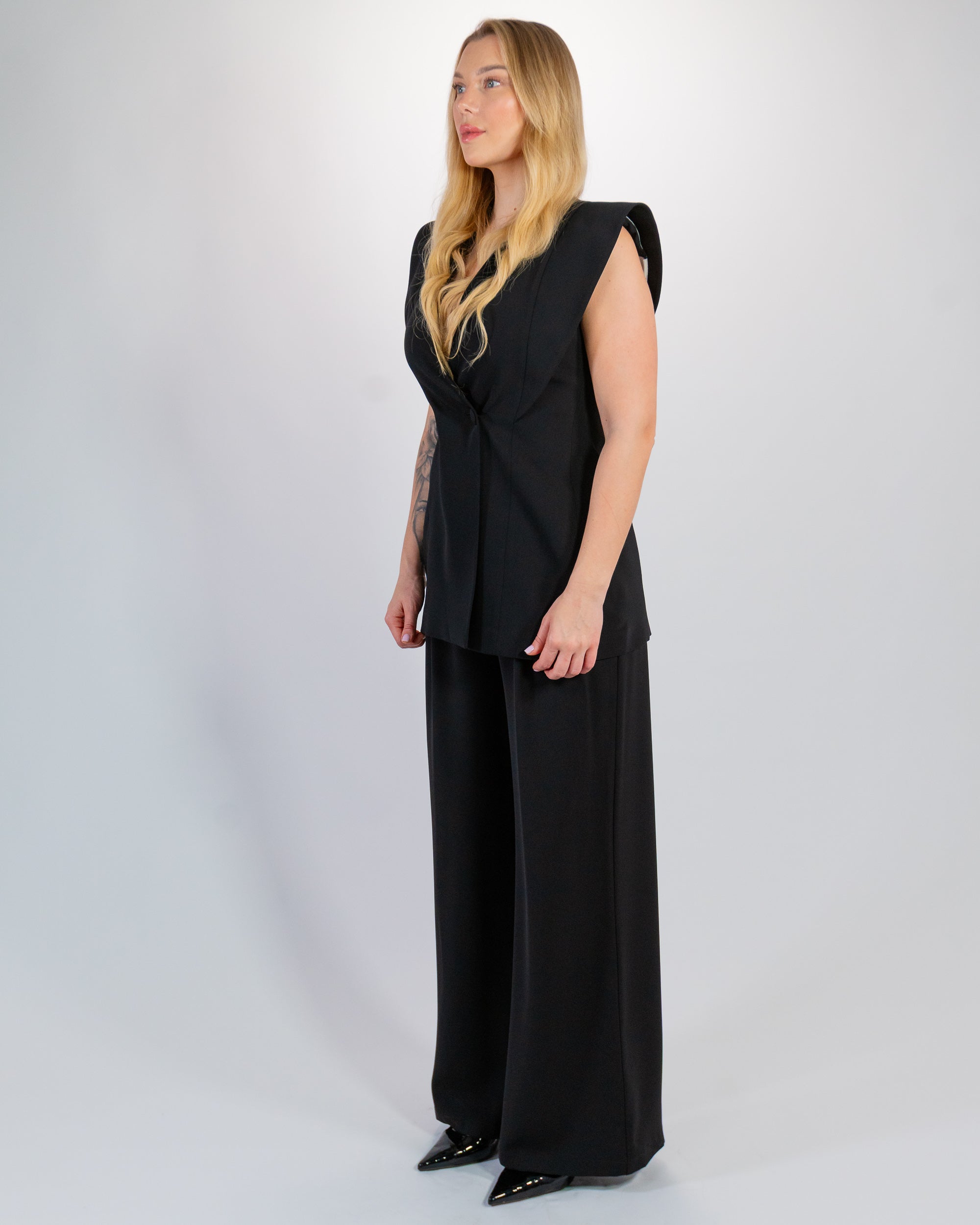 Structured black suit – Padded shoulders & flowing trousers